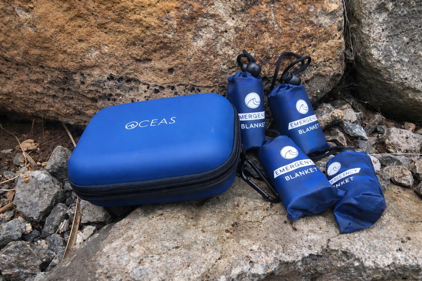 Compact emergency blankets packed in small pouches beside a carry case
