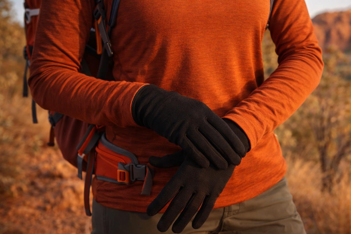 Hiker wearing lightweight liner gloves during cool weather walking