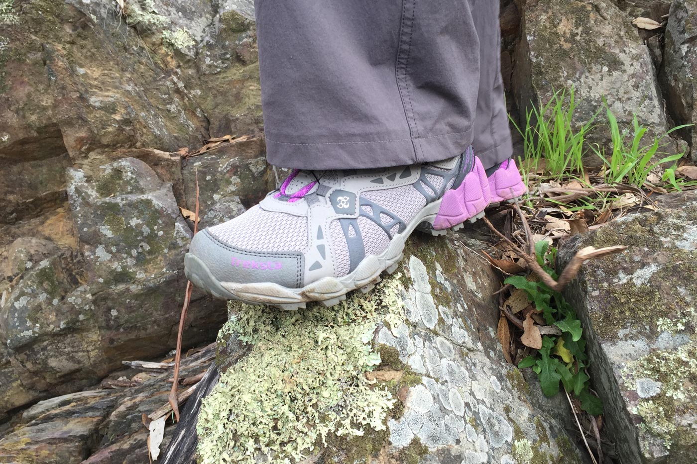 Knit and engineered mesh hiking shoes showing breathable upper and flexible fit on rocky terrain.