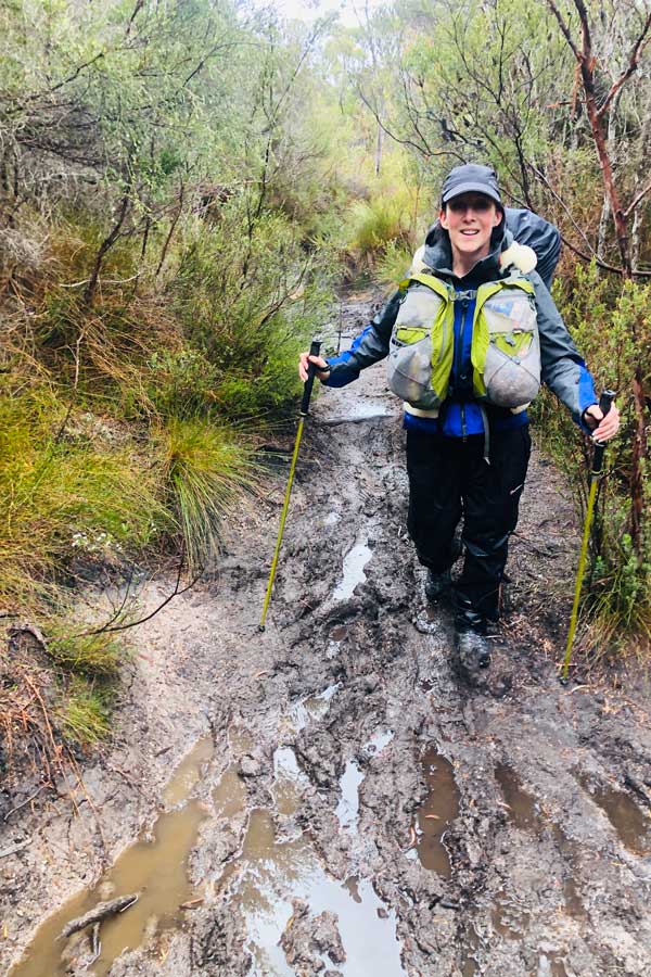 Julie-Edwards-walking-along-muddy-trail Image of julie walking along muddy trail