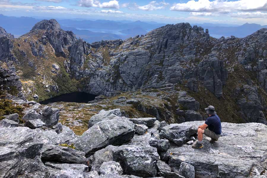Planning Guide: Western Arthur Range Traverse Image of darren looking across square lake from mount sirius