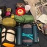 A group of camping equipment on a bed