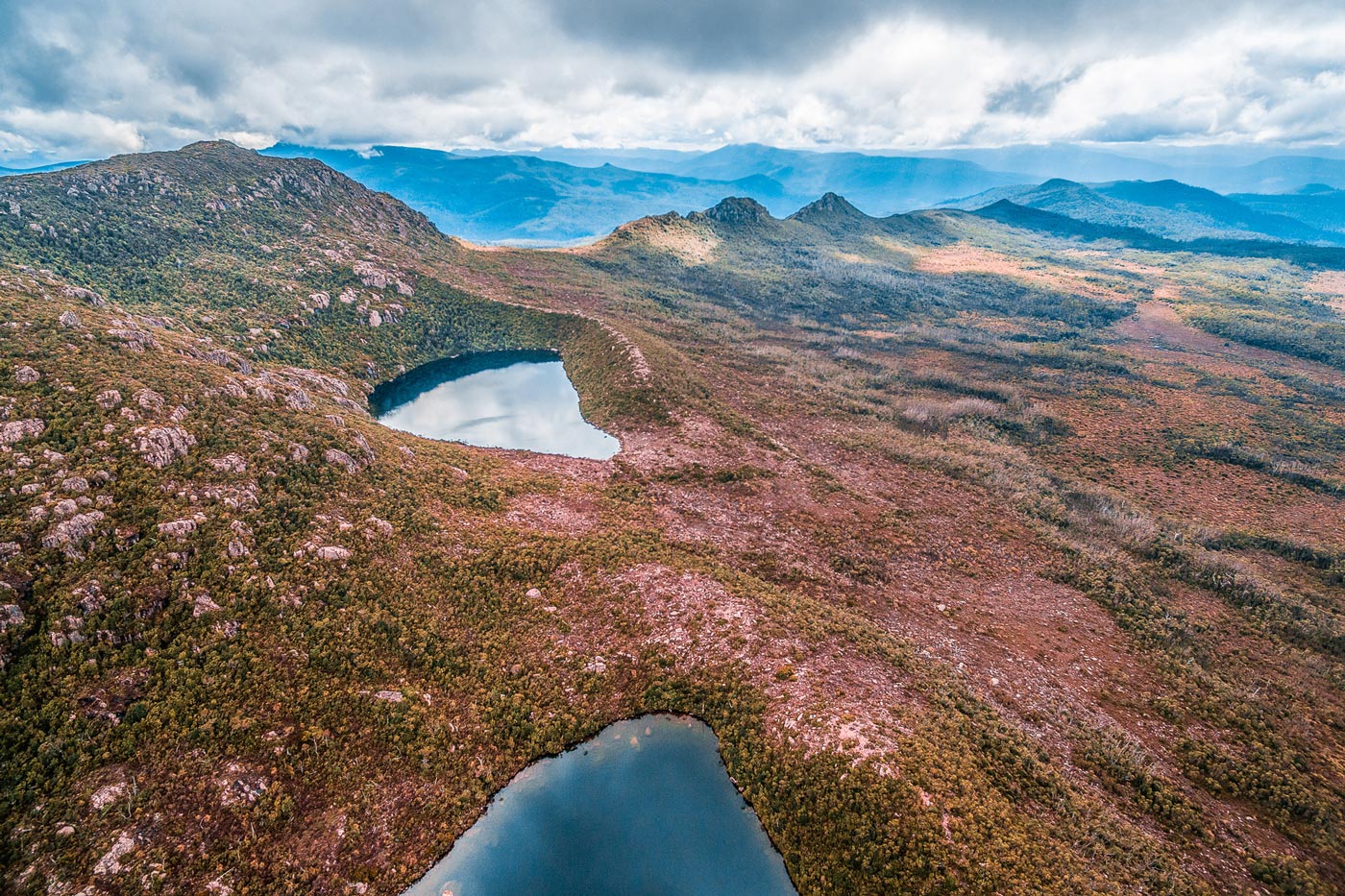 Aerial view of glacial lakes set among dolerite ridges and alpine vegetation in hartz mountains national park, tasmania.