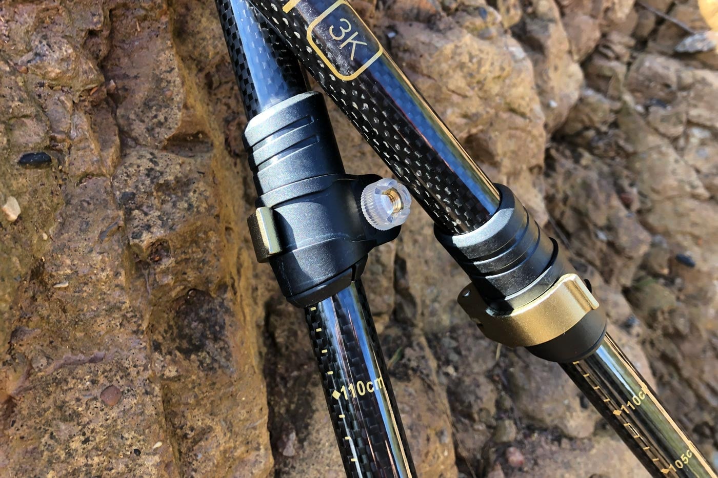 Close-up of adjustable hiking poles showing telescopic sections and locking mechanisms used to change pole length