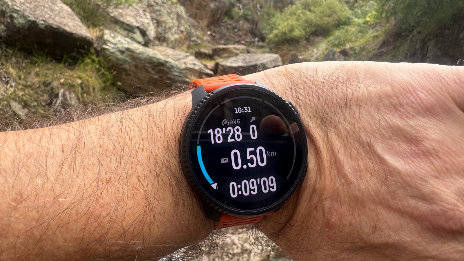 Suunto vertical 2 in use on the trail, showing distance, time, and pace during a hike.