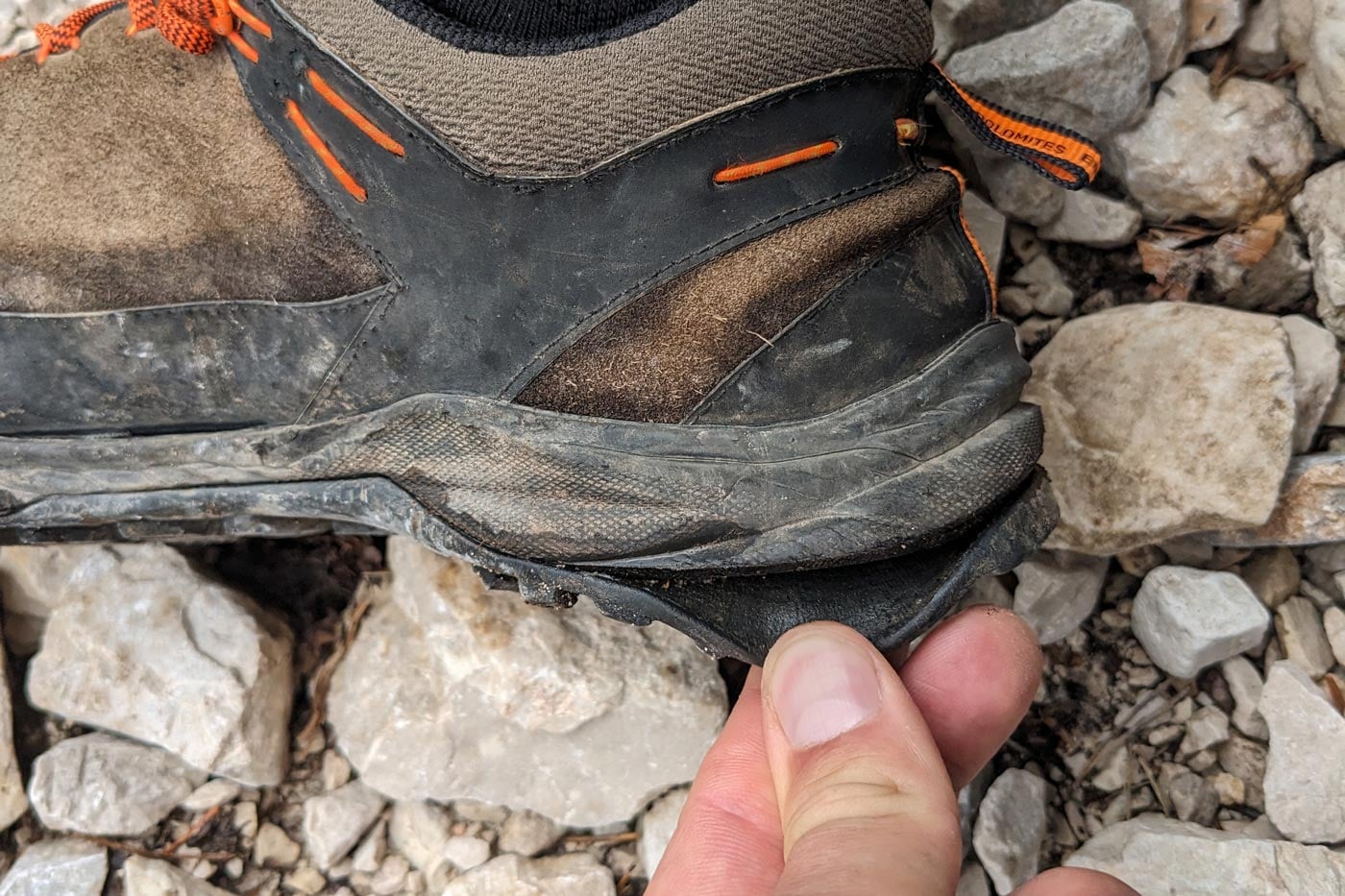 Close-up of a hiking boot with the sole starting to separate from the upper, highlighting early signs of footwear failure discovered during inspection