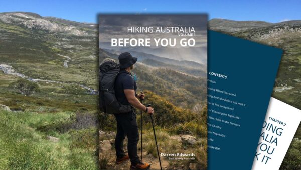Volume-1-16x9-image Hiker overlooking mountain ranges at sunrise