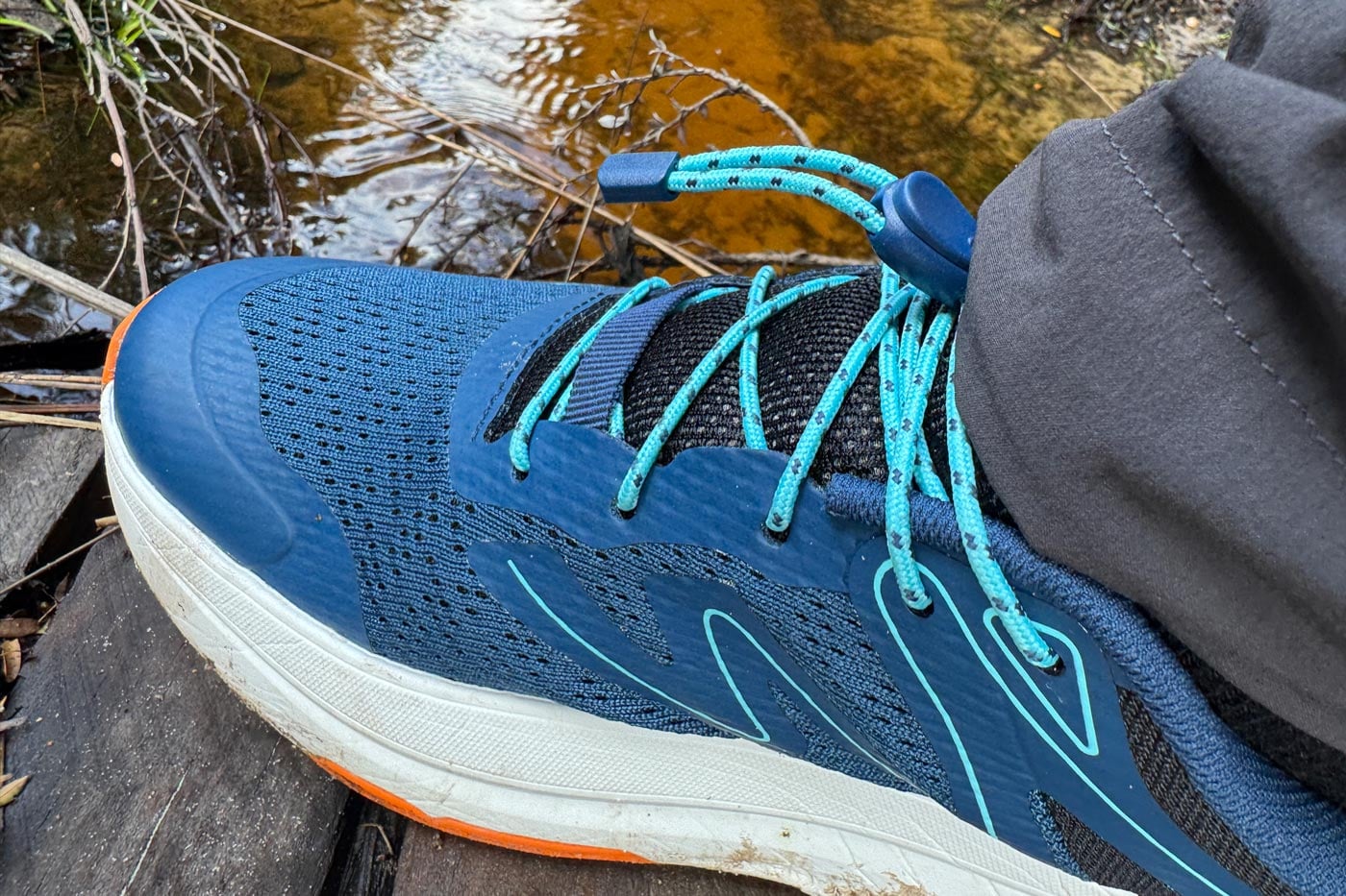 Teva Hurricane Trailsetter Shoe Review Teva hurricane trailsetter in blue opal multi colourway showing mesh upper and speed lace system near a creek