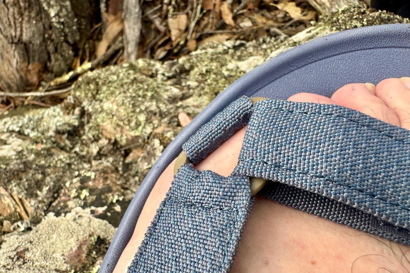 Close-up of the adjustable forefoot strap on a zorali sandal, showing the recycled polyester webbing and the hardware buckle.