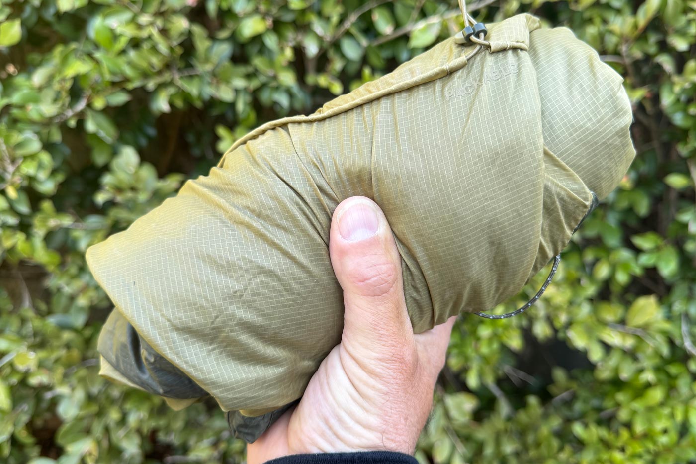 Close-up of a packed ridgelite futurefleece wind jacket showing the lightweight fabric and compact storage size.
