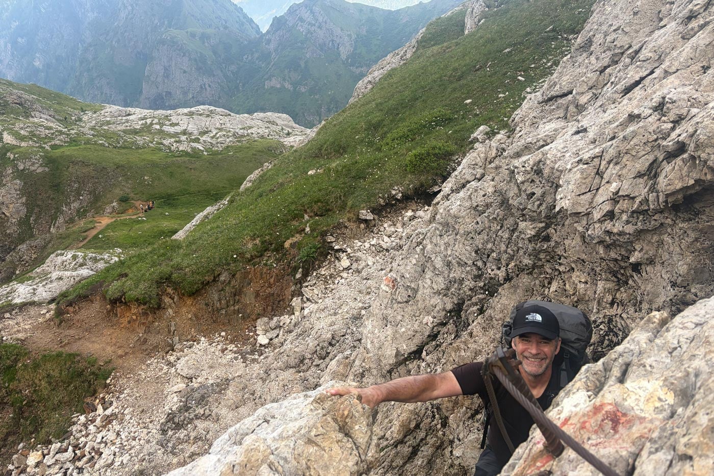 Hiker wearing a snowgum merino 180 merano tee while scrambling on exposed alpine terrain during the alta via 2 trek