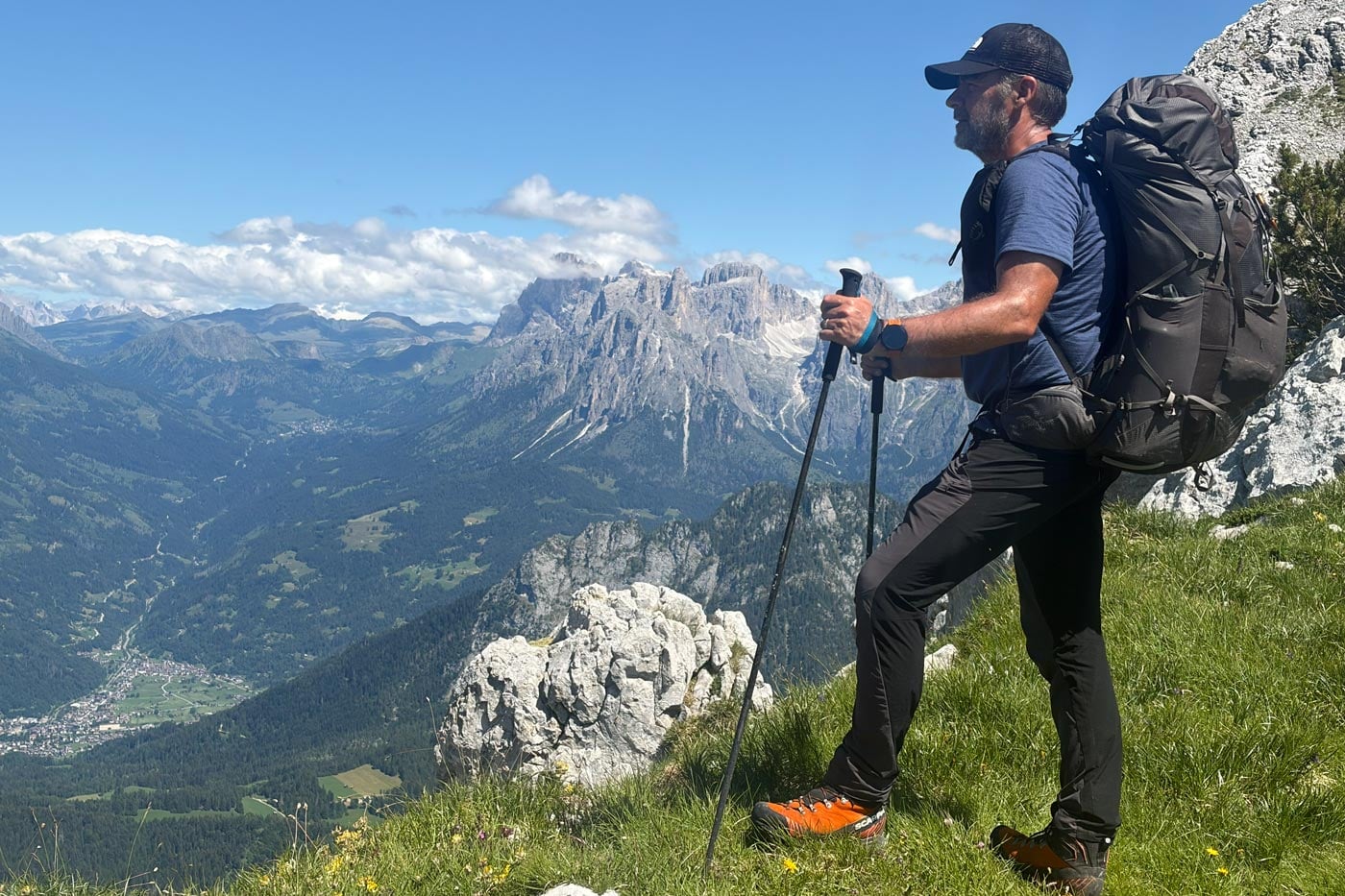 Hiker wearing a snowgum merino 180 merano tee on a scenic alpine trail during the alta via 2 trek in the dolomites