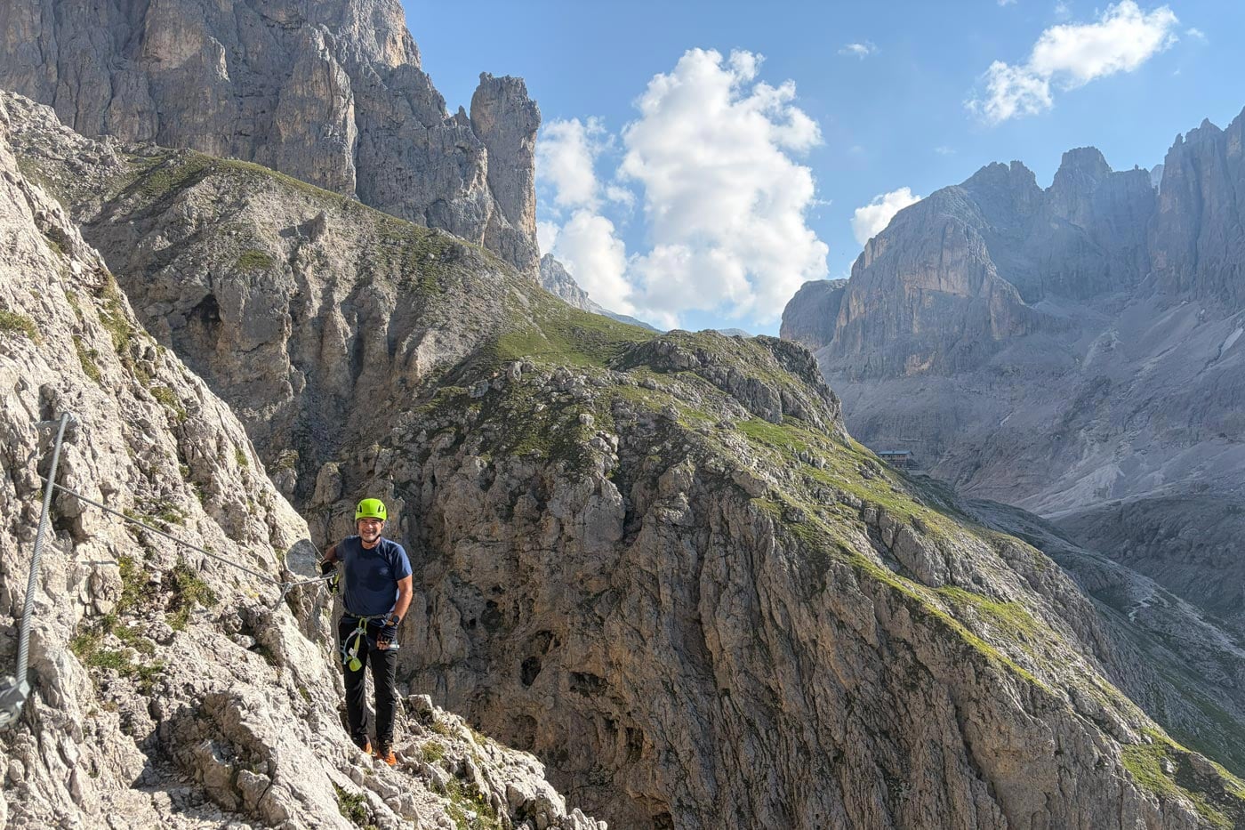 Hiker wearing a snowgum merino 180 merano tee on an exposed alpine section of the alta via 2 in the dolomites