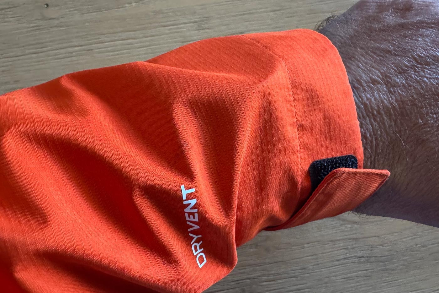 Close-up of a waterproof jacket sleeve showing the adjustable hook-and-loop cuff and dryvent branding.